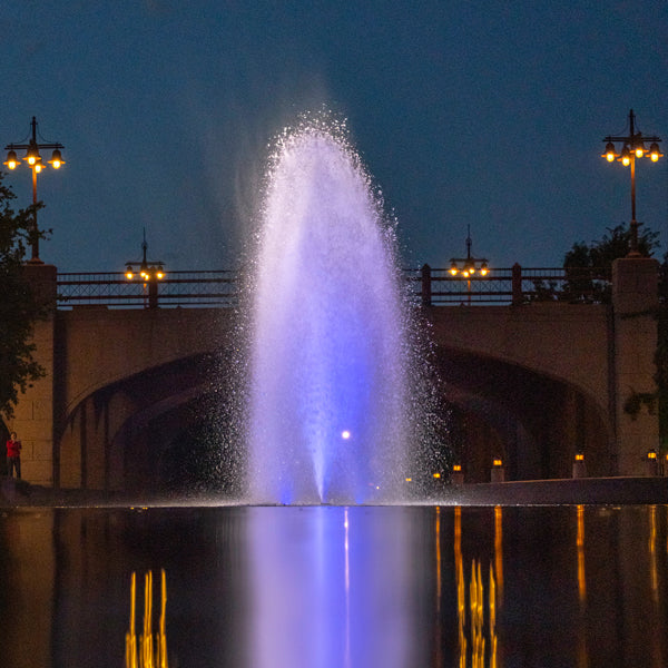 Fountain with blue light at night in an urban setting